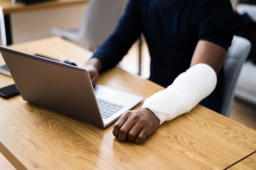 injured person on a laptop